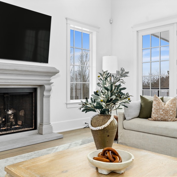 Open gas fireplace with custom limestone surround in living room